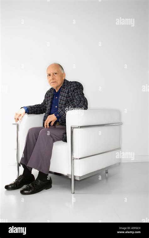 Caucasian Mature Adult Male Sitting In Chair Looking At Viewer Stock Photo Alamy