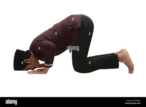 Young Asian Muslim Man With Praying Position Isolated Over White