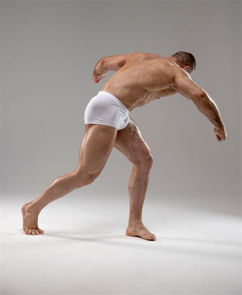 Premium Photo Full Length Portrait Of Attractive Muscled Naked Man Posing Raised Hands Up In