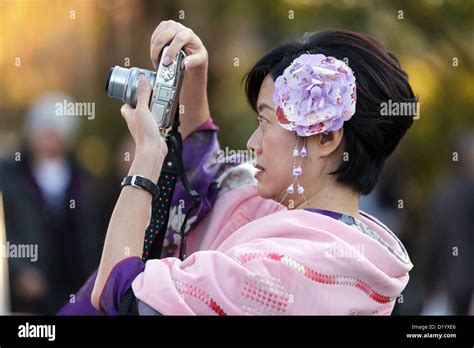 Mature Japanese Woman Taking Photo In Street Tokyo Japan Stock Photo Alamy