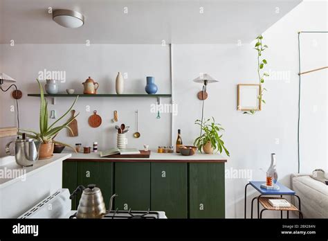 Interior Of Kitchen Stove Counter With Shelving Pottery Plants Stock