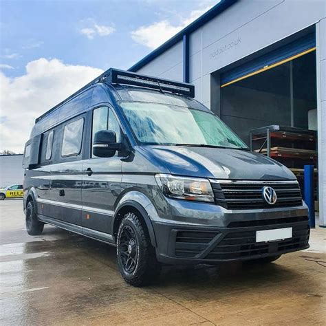 A Grey Van Parked In Front Of A Building