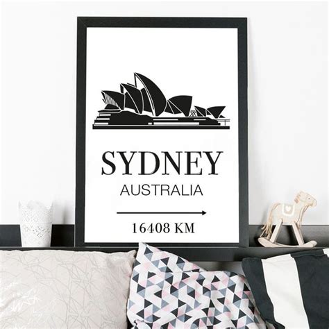 A Black And White Poster With The Name Sydney On It In Front Of A Bed