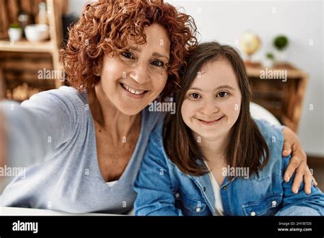 Mature Mother And Down Syndrome Daughter At Home Taking A Picture Stock Photo Alamy