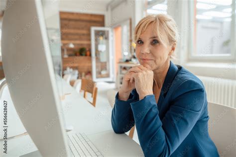Mature Businesswoman In Front Of Desktop PC At Office Desk Stock Photo Adobe Stock