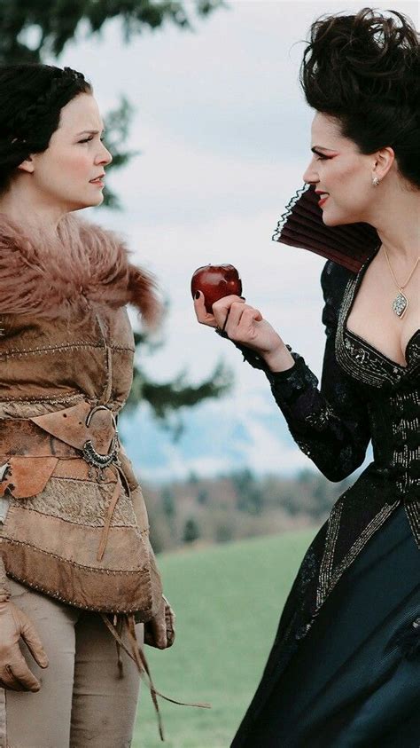 Two Women Dressed In Period Clothing One Holding An Apple And The Other