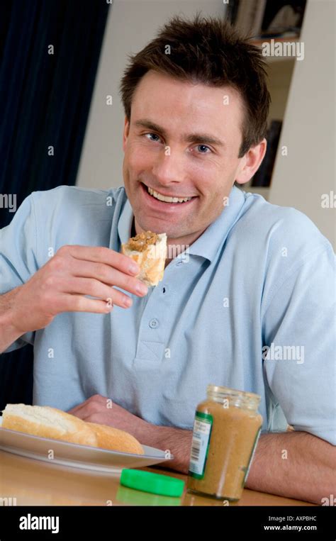 man eating a peanut butter sandwich Stock Photo - Alamy