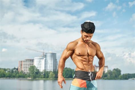 Sportsman With Naked Torso Showing Muscles Near Lake Stock Photo Image Of Horizontal