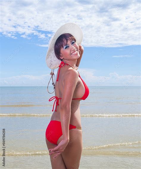 Sexy Asian Red Bikini Female Lady Model Having A Great Holiday By A Beach And Posing Happily