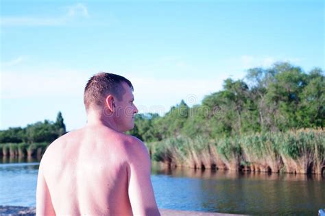 Man With A Naked Torso On The Beach Looks Into The Distance Stock Photo Image Of Torso
