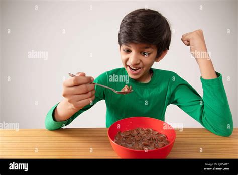 Portrait Of An Excited Boy Eating Milk Chocos Stock Photo Alamy