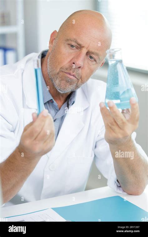 Mature Gentleman Using A Pipette Stock Photo Alamy