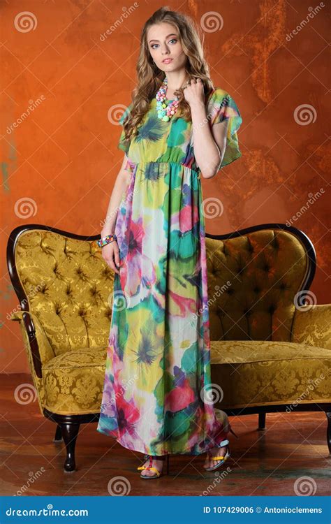 Attractive Slender Blonde Model Posing And Standing In Full Height On High Heels Stock Photo