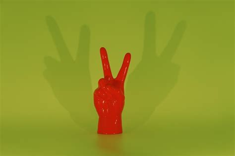 Premium Photo Red Peace Sign Hand Green Background