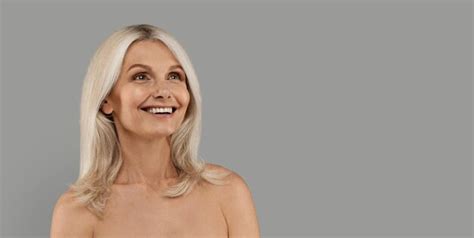 Premium Photo Beautiful Mature Lady With Bare Shoulders Looking At Copy Space With Excitement