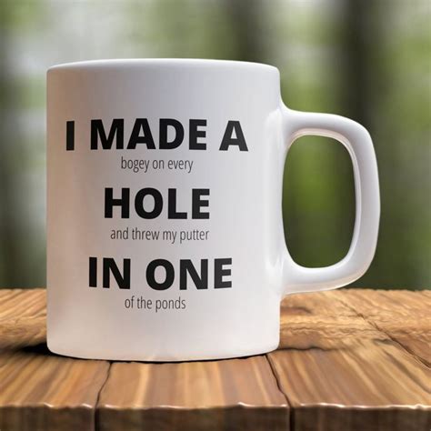 A White Coffee Mug That Says I Made A Hole In One Of The Pondies
