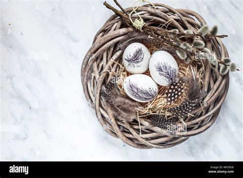 Painted Easter Eggs In Nest With Straw Feathers And Pussy Willows Stock Photo Alamy