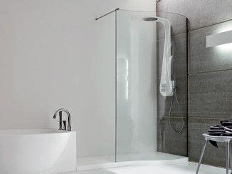 A Bathroom With A Large White Bathtub Next To A Stand Up Shower And Sink