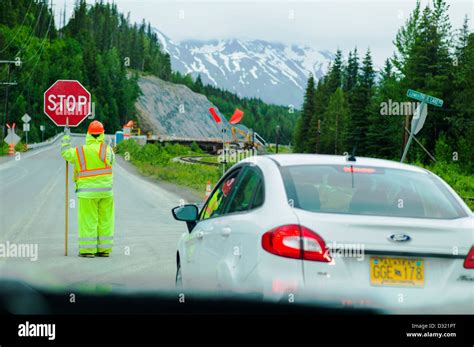 Flagger Or Flag Person Stops Traffic For Construction On Highway 1