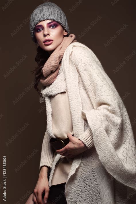 Beautiful Sexy Long Haired Brunette Woman In Knitted Clothes Posing In The Studio The Beauty Of