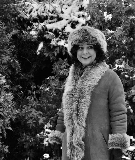 Beautiful Mature Brunette Woman Sheepskin Coat Against Snow Stock
