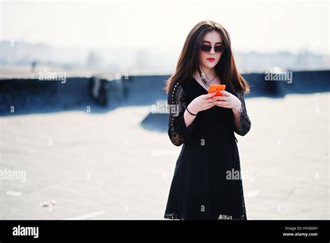 Portrait Brunette Girl With Red Lips And Orange Mobile Phone At Hands