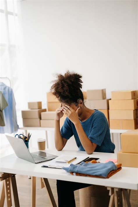 Calm Curly Brunette Dark Skinned Woman On Desk In Modern Office Of Fashion Designer And Holds
