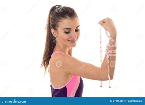 Brunette Girl In Body Bathing Suit Shows Biceps On Arm And Measuring Tape And Smiling Isolated