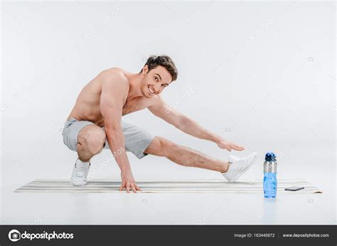 young man stretching stock photo  dimagavrish