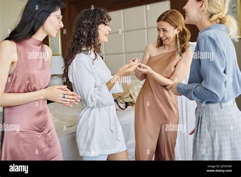 Happy Mature Woman In Beige Silk Long Dress Giving Pearl Necklace To