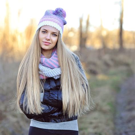 Beautiful Woman Wearing Hat Scarf And Down Jacket In Cold Weather