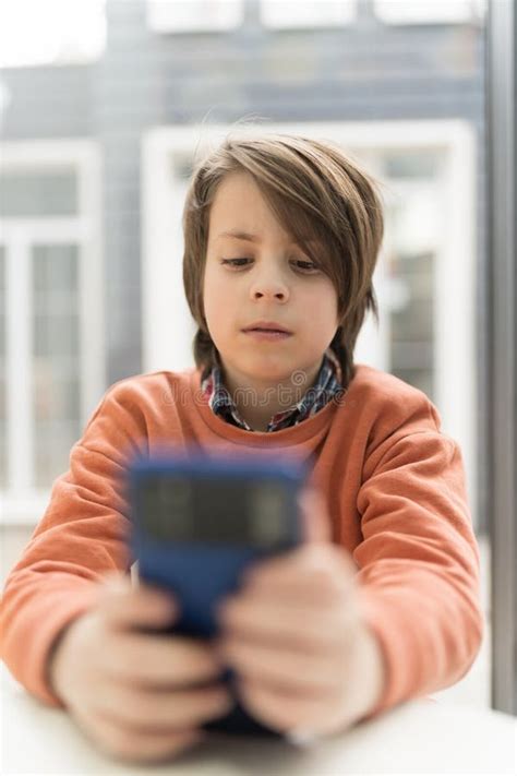 Handsome Little Boy Playing Online Game On A Smart Phone Portrait Of