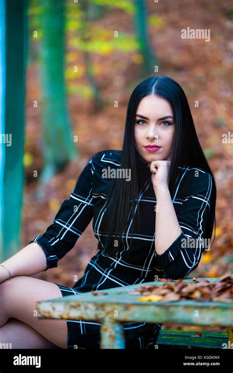 Picture With A Beautiful Brunette In The Autumn Forest Near To A Wooden House Stock Photo Alamy