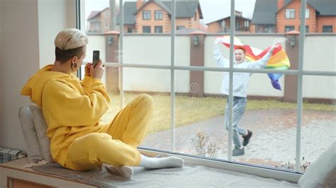 Joyful Woman Watching Her Lesbian Partner Dance With A Pride Flag Outside Stock Video Video Of