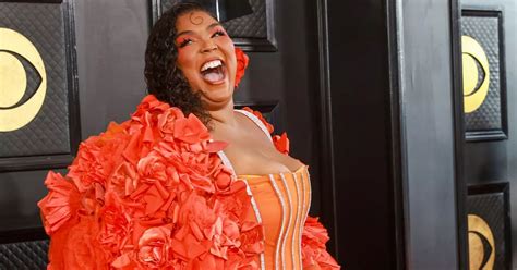 Lizzo Wows As She Pours Curves Into Orange Flower Ensemble At Grammys