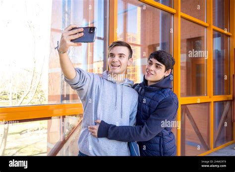 Couple Gay College Boyfriends Taking A Picture With A Cell Phone Stock Photo Alamy