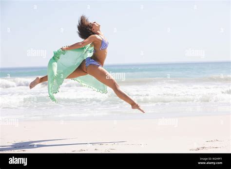 Woman In Bikini With Scarf Jumping On The Beach Stock Photo Alamy