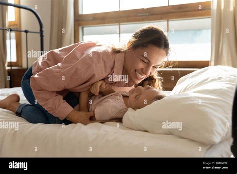 Lachende Mutter Kitzeln Liebenswert Kleine Tochter Auf Dem Bett Liegen