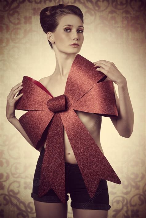 Lovely Blonde Woman Adorned Like A Sensual Christmas Present With Big Red Bow On Her Naked