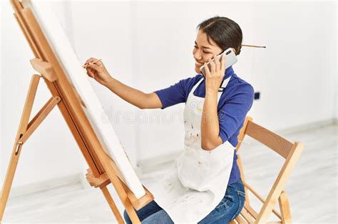 Joven Latina Hablando En El Dibujo De Un Smartphone En El Estudio De Arte Foto De Archivo