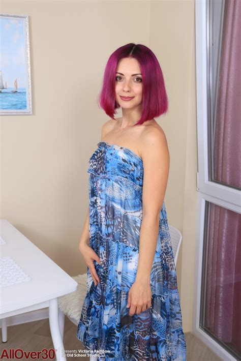 Purple Haired Milf Beauty Victoria Rainbow Strips And Shows Her Shaved Cunt Photos