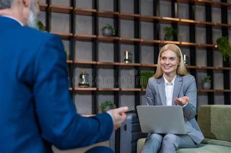 Blonde Business Woman Having An Interview With A Work Candidate And Looking Involved Stock Image