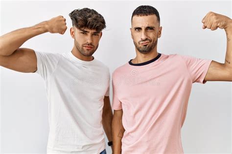 Joven Pareja Gay Parado Sobre El Fondo Blanco Aislado Guiñando La Mirada a La Cámara Con Una