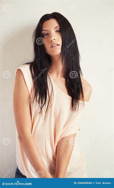 Giving You A Seductive Stare Portrait Of A Beautiful Brunette Staring Seductively At The Camera