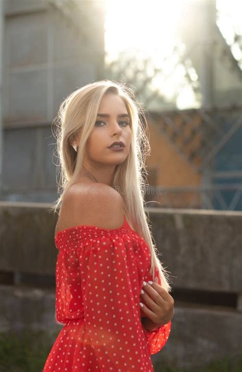 Luxurious Blonde Model With Naked Shoulders In Red Dress Posing Stock Image Image Of Street