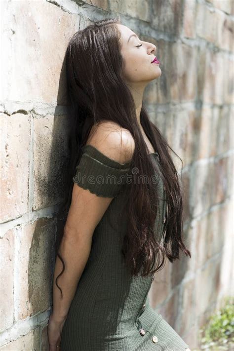 A Lovely Brunette Model Enjoys An Spring Day Outdoors Stock Photo