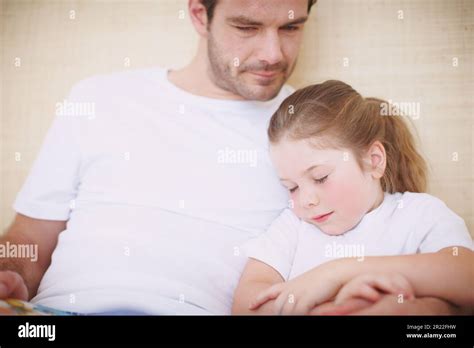 Falling Asleep In Her Fathers Arms A Devoted Father Siting With His