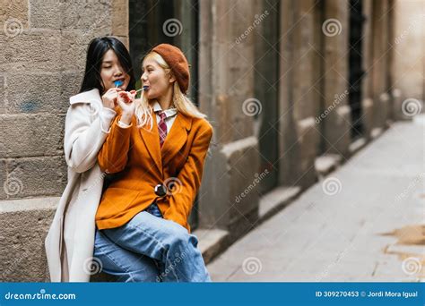 Lesbian Couple Eating Lollipops Together Outdoors Stock Image Image Of Asian Outdoors