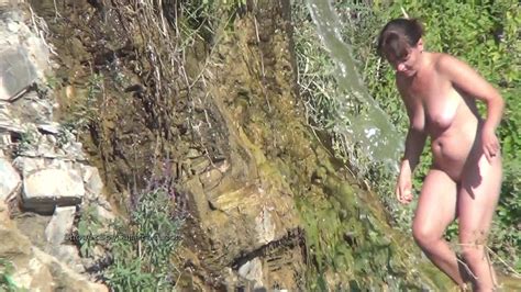 Tasty Brunette Washes Her Hands With Cold Water In Nature