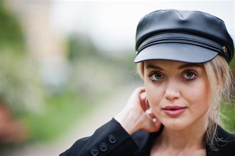 Close Up Portrait Of Beautiful Blonde Fashion Woman Model In Cap And In All Black With Bright